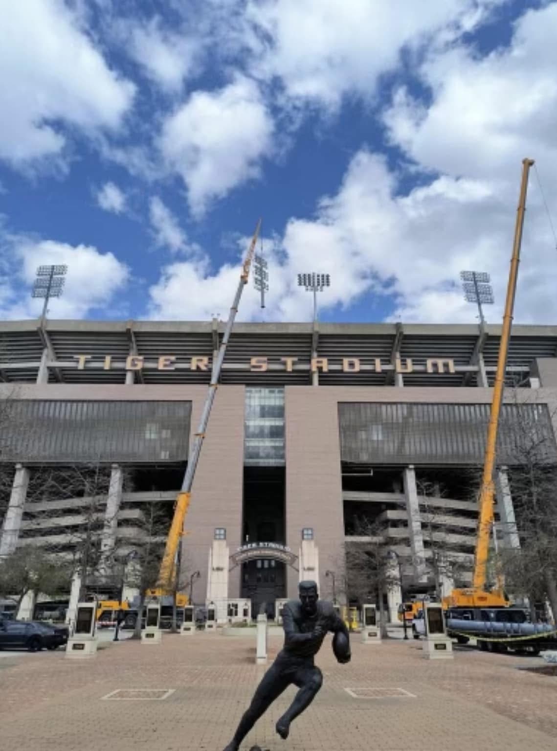 Two capitol company cranes fully erected in front of tiger stadium