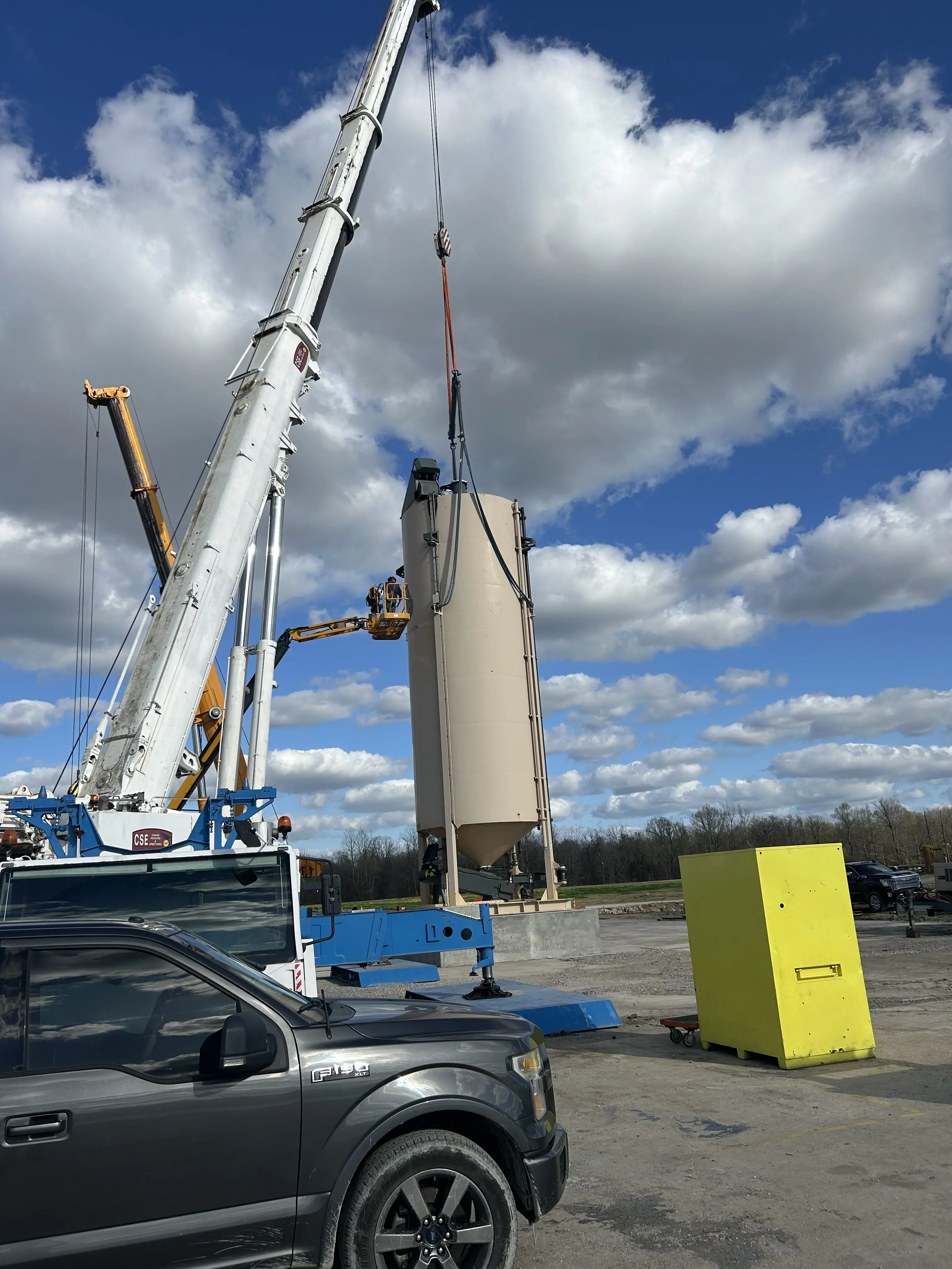 Large crane moving a cooling tower on a clear day